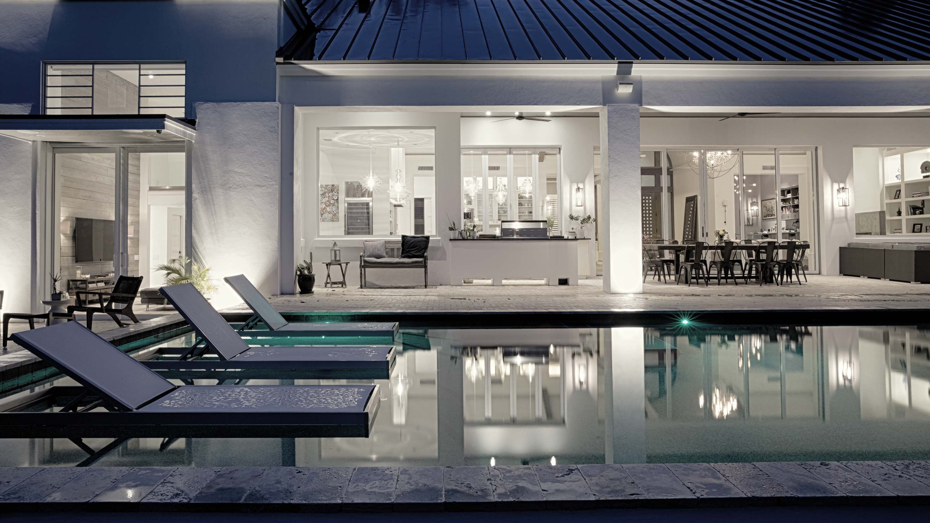 cool toned image of a pool with lutron lighting at a house